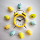 Easter eggs around yellow alarm clock on white background Easter eggs around yellow alarm clock on white background - PhotoDune Item for Sale