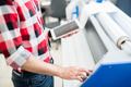 Crop man with tablet using printing equipment Crop man with tablet using printing equipment - PhotoDune Item for Sale