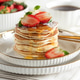 Stack of Golden Pancakes with Strawberry and Coffee on White Table Stack of Golden Pancakes with Strawberry and Coffee on White Table - PhotoDune Item for Sale