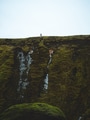 Man on a green ledge walking. Man on a green ledge walking. - PhotoDune Item for Sale