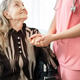 Nurse standing beside senior woman and holding hands to encourage woman to cure from disease. Nurse standing beside senior woman and holding hands to encourage woman to cure from disease. - PhotoDune Item for Sale