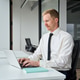 Busy businessman financial analyst or manager using computer at work. Vertical Busy businessman financial analyst or manager using computer at work. Vertical - PhotoDune Item for Sale