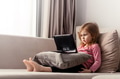 Cute todller girl sitting on couch, using tablet pad laptop gadget, watching cartoons at home Cute todller girl sitting on couch, using tablet pad laptop gadget, watching cartoons at home - PhotoDune Item for Sale