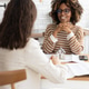 confident curly haired woman with curly dark hair, designer or realtor, shows mock up house. confident curly haired woman with curly dark hair, designer or realtor, shows mock up house. - PhotoDune Item for Sale