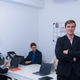Professional office setting featuring four individuals engaged work. One man stand foreground Professional office setting featuring four individuals engaged work. One man stand foreground - PhotoDune Item for Sale