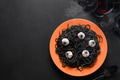 Halloween Italian black pasta decorated horror eyes in orange plate on black . Halloween Italian black pasta decorated horror eyes in orange plate on black . - PhotoDune Item for Sale