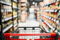 Shopping cart between shelves in food store Shopping cart between shelves in food store - PhotoDune Item for Sale