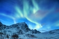 Aurora borealis on the Lofoten islands, Norway. Green northern lights above mountains. Aurora borealis on the Lofoten islands, Norway. Green northern lights above mountains. - PhotoDune Item for Sale