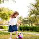 A little girl playing with a soft colorful ball in the park. Happy children in a garden having fun. A little girl playing with a soft colorful ball in the park. Happy children in a garden having fun. - PhotoDune Item for Sale
