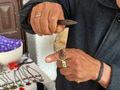 Craftsman Proudly Displaying his Handmade Piece of Finished Jewelry Work at his Small Business Shop. Craftsman Proudly Displaying his Handmade Piece of Finished Jewelry Work at his Small Business Shop. - PhotoDune Item for Sale