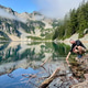Man kneeling at alpine lake Man kneeling at alpine lake - PhotoDune Item for Sale