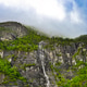 Stunning Waterfall Cascading Down a Rocky Fjord Wall in Norway Stunning Waterfall Cascading Down a Rocky Fjord Wall in Norway - PhotoDune Item for Sale