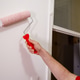 Person painting a wall with a roller in a room during the day Person painting a wall with a roller in a room during the day - PhotoDune Item for Sale