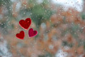 Red magenta hearts on window with rain drops and brown green background with copy space Red magenta hearts on window with rain drops and brown green background with copy space - PhotoDune Item for Sale