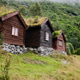 Traditional Norwegian houses made of wood, stand on stones. Grass on roof. Lovatnet lake. Traditional Norwegian houses made of wood, stand on stones. Grass on roof. Lovatnet lake. - PhotoDune Item for Sale