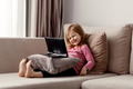 Cute todller girl sitting on couch, using tablet pad laptop gadget, watching cartoons at home Cute todller girl sitting on couch, using tablet pad laptop gadget, watching cartoons at home - PhotoDune Item for Sale