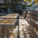Table and bench in street cafe covered with fallen autumn leaves, autumn city background Table and bench in street cafe covered with fallen autumn leaves, autumn city background - PhotoDune Item for Sale
