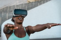 Happy fit African woman using virtual reality headset during training session Happy fit African woman using virtual reality headset during training session - PhotoDune Item for Sale