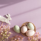 Easter Bunny Stick and Pastel Eggs with Flowers on Purple Background Easter Bunny Stick and Pastel Eggs with Flowers on Purple Background - PhotoDune Item for Sale