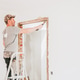 A young Caucasian male builder clears a doorway using a crowbar. A young Caucasian male builder clears a doorway using a crowbar. - PhotoDune Item for Sale