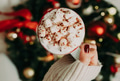 Close up of women's hands holding white mug with hot cocoa, tea or coffee and marshmallow. Close up of women's hands holding white mug with hot cocoa, tea or coffee and marshmallow. - PhotoDune Item for Sale