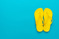 Yellow Beach Flip-Flops On The Blue Background Yellow Beach Flip-Flops On The Blue Background - PhotoDune Item for Sale