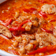 Tikka masala with chicken and chickpeas in red pot. Tikka masala with chicken and chickpeas in red pot. - PhotoDune Item for Sale