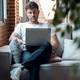 Smart man working with her laptop while sitting on a couch at home Smart man working with her laptop while sitting on a couch at home - PhotoDune Item for Sale