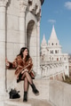 Portrait of stylish young woman sitting on walls of Fisherman's bastion in Budapest, Hungary Portrait of stylish young woman sitting on walls of Fisherman's bastion in Budapest, Hungary - PhotoDune Item for Sale