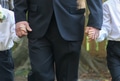 Closeup View of Father and Kids Holding Hands during Wedding Ceremony Wearing Formal Clothing. Closeup View of Father and Kids Holding Hands during Wedding Ceremony Wearing Formal Clothing. - PhotoDune Item for Sale