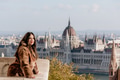 Portrait of beautiful young woman on balcony overlooking Hungarian Parliament in Budapest, Hungary Portrait of beautiful young woman on balcony overlooking Hungarian Parliament in Budapest, Hungary - PhotoDune Item for Sale