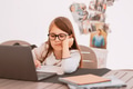 Girl wearing eyeglasses, using notebook, sitting at table at home, studying. Back to school Girl wearing eyeglasses, using notebook, sitting at table at home, studying. Back to school - PhotoDune Item for Sale