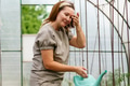 Mature woman with watering can gardening in greenhouse at home - shot in slow motion Mature woman with watering can gardening in greenhouse at home - shot in slow motion - PhotoDune Item for Sale