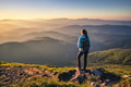 Girl on mountain peak looking at beautiful mountains at sunset Girl on mountain peak looking at beautiful mountains at sunset - PhotoDune Item for Sale