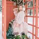 A little girl stands near a pink telephone booth filled with flowers in a snowy forest. Spring A little girl stands near a pink telephone booth filled with flowers in a snowy forest. Spring - PhotoDune Item for Sale