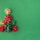 Christmas Gift Bows Arranged into a Festive Holiday Tree on Green Background Christmas Gift Bows Arranged into a Festive Holiday Tree on Green Background - PhotoDune Item for Sale