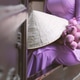 A woman in traditional Vietnamese dress sitting with a bunch of pink lotuses on her lap A woman in traditional Vietnamese dress sitting with a bunch of pink lotuses on her lap - PhotoDune Item for Sale