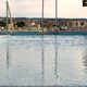 Rooftop pool with calm turquoise water and urban skyline view. Rooftop pool with calm turquoise water and urban skyline view. - PhotoDune Item for Sale