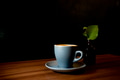 Coffee in blue cup on wooden table in cafe with dark background Coffee in blue cup on wooden table in cafe with dark background - PhotoDune Item for Sale