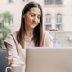 woman working on a laptop in a bright cafe, enjoying a coffee break woman working on a laptop in a bright cafe, enjoying a coffee break - PhotoDune Item for Sale