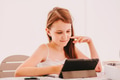 Little girl, preteen, sitting at table and using tablet pad. Kid taking lessons online. Video chat Little girl, preteen, sitting at table and using tablet pad. Kid taking lessons online. Video chat - PhotoDune Item for Sale