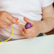 Child Putting Beads on a String Child Putting Beads on a String - PhotoDune Item for Sale