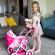 Young girl playing with toy stroller and stuffed bunny in living room Young girl playing with toy stroller and stuffed bunny in living room - PhotoDune Item for Sale