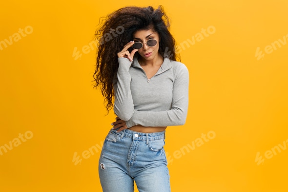 COOL OFFER. Sexy pretty millennial Latin female with afro in sunglasses and casual clothes, stay Stock Photo by shotprime COOL OFFER. Sexy pretty millennial Latin female with afro in sunglasses and casual clothes, stay Stock Photo by shotprime
