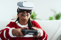 African senior woman having fun with new gaming virtual reality technology experience African senior woman having fun with new gaming virtual reality technology experience - PhotoDune Item for Sale