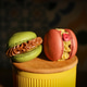 Two macarons, green with caramelized nuts and red with raspberry pieces and cream Two macarons, green with caramelized nuts and red with raspberry pieces and cream - PhotoDune Item for Sale