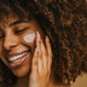 Beautiful black woman applying face luxury sunscreen or moisturizer cream Beautiful black woman applying face luxury sunscreen or moisturizer cream - PhotoDune Item for Sale