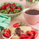 Crepes with chocolate spread and fresh strawberries, served with tea on pink background Crepes with chocolate spread and fresh strawberries, served with tea on pink background - PhotoDune Item for Sale