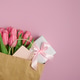 Gift Bag with Pink Tulips and Gift Box on Pink Background. Valentines or Mothers Day Celebration Gift Bag with Pink Tulips and Gift Box on Pink Background. Valentines or Mothers Day Celebration - PhotoDune Item for Sale