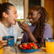 Lesbian couple sharing avocado toast at home during breakfast Lesbian couple sharing avocado toast at home during breakfast - PhotoDune Item for Sale